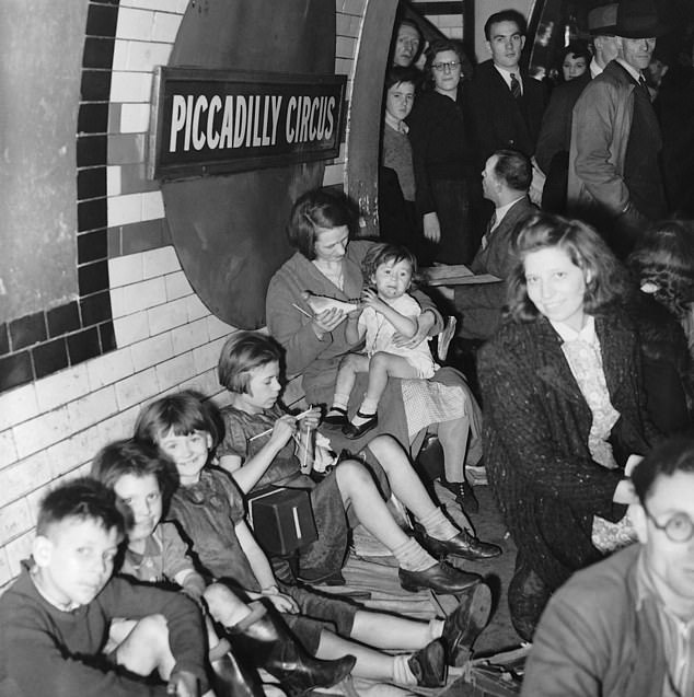 Londoners sheltering at Picadilly Circus during World War II. The Blitz spirt: children still smiling