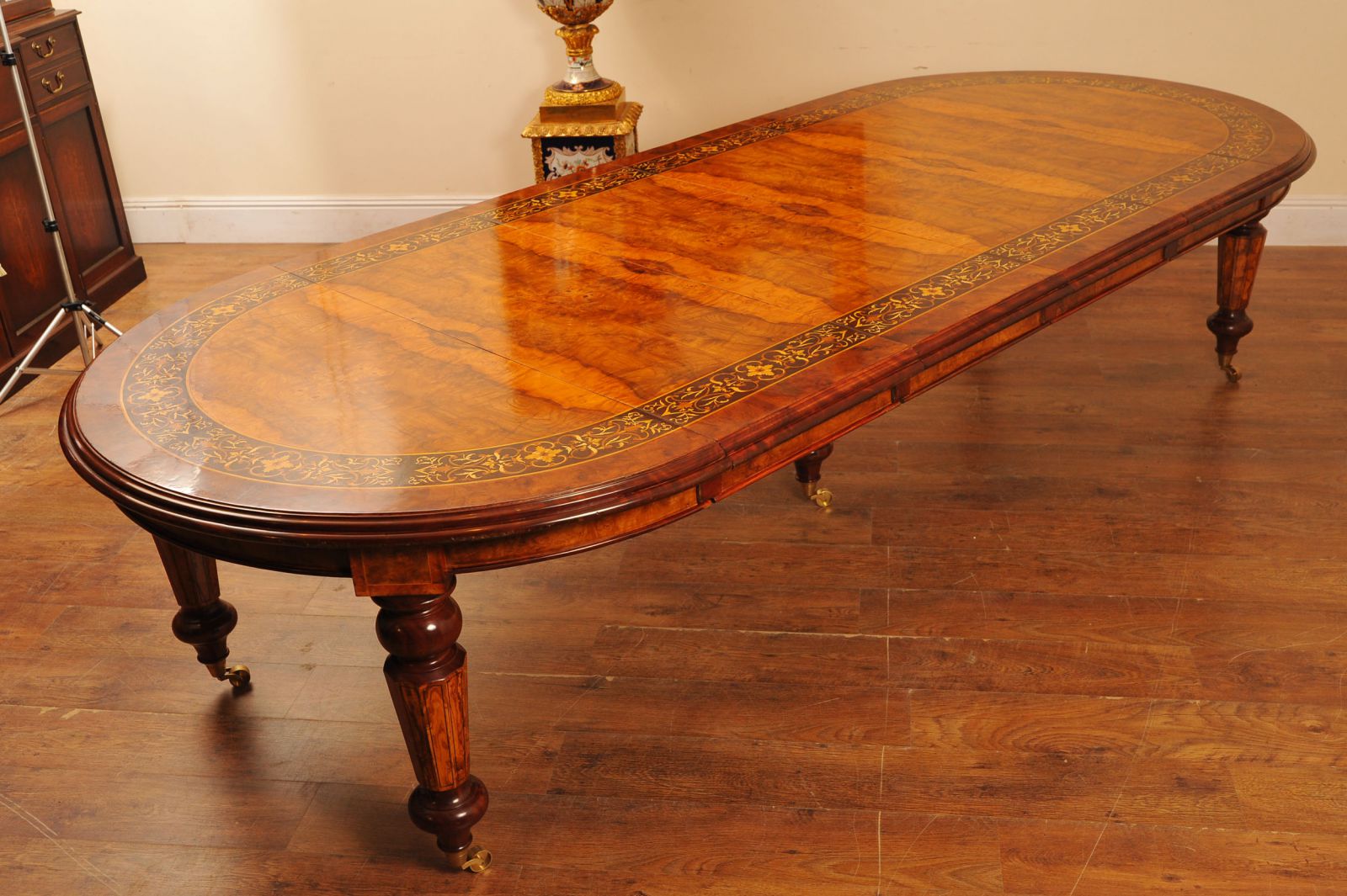 This is a walnut Victorian dining table with marquetry inlay work