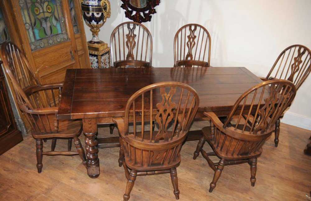 Set Windsor Chairs around the oak refectory table with barley twist legs